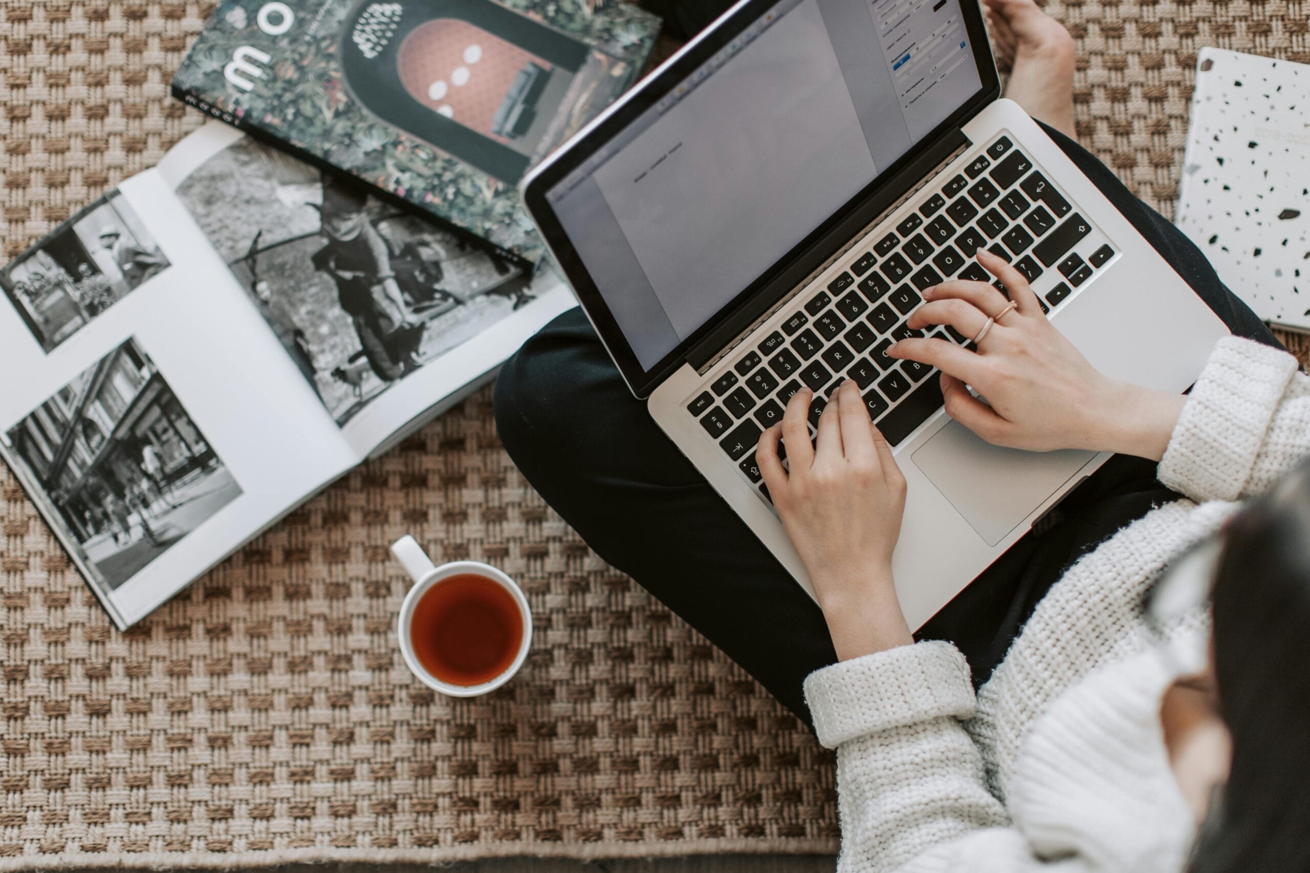 CFO FACTORY training IMA accredited Egypt Middle East – Person working on a laptop with books and coffee nearby symbolizing modern finance education – Become a transformative leader in finance